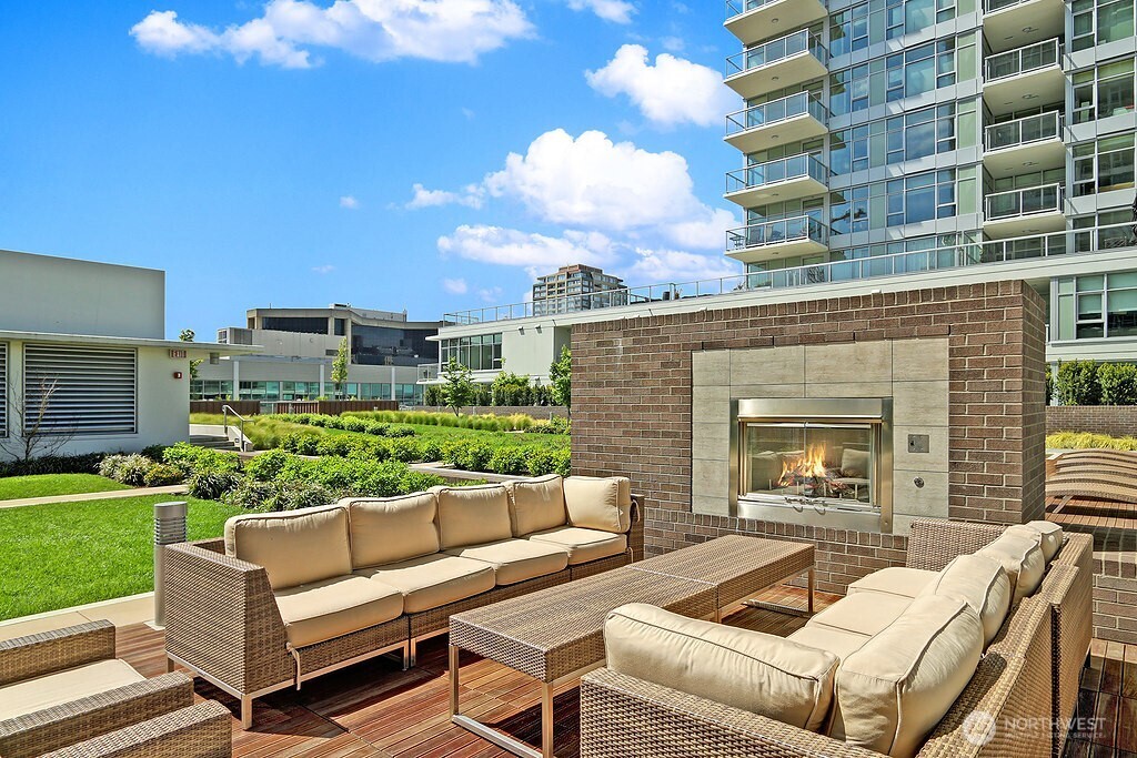 583 Battery Street, Unit 1405N Seattle, WA 98121 - Photo 19 of 37 a view of a patio with couches table and chairs with garden and plants