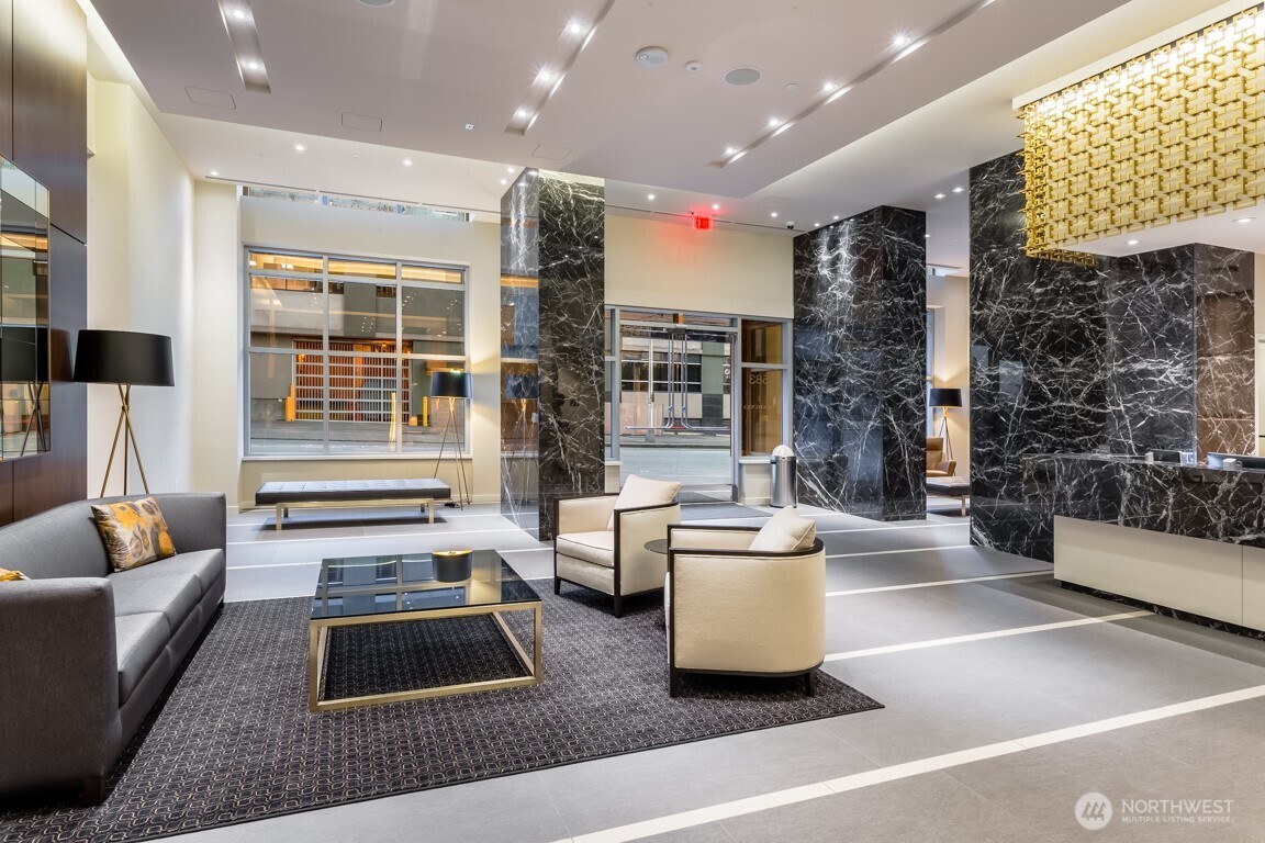 583 Battery Street, Unit 1405N Seattle, WA 98121 - Photo 36 of 37 a living room with furniture a rug and a chandelier