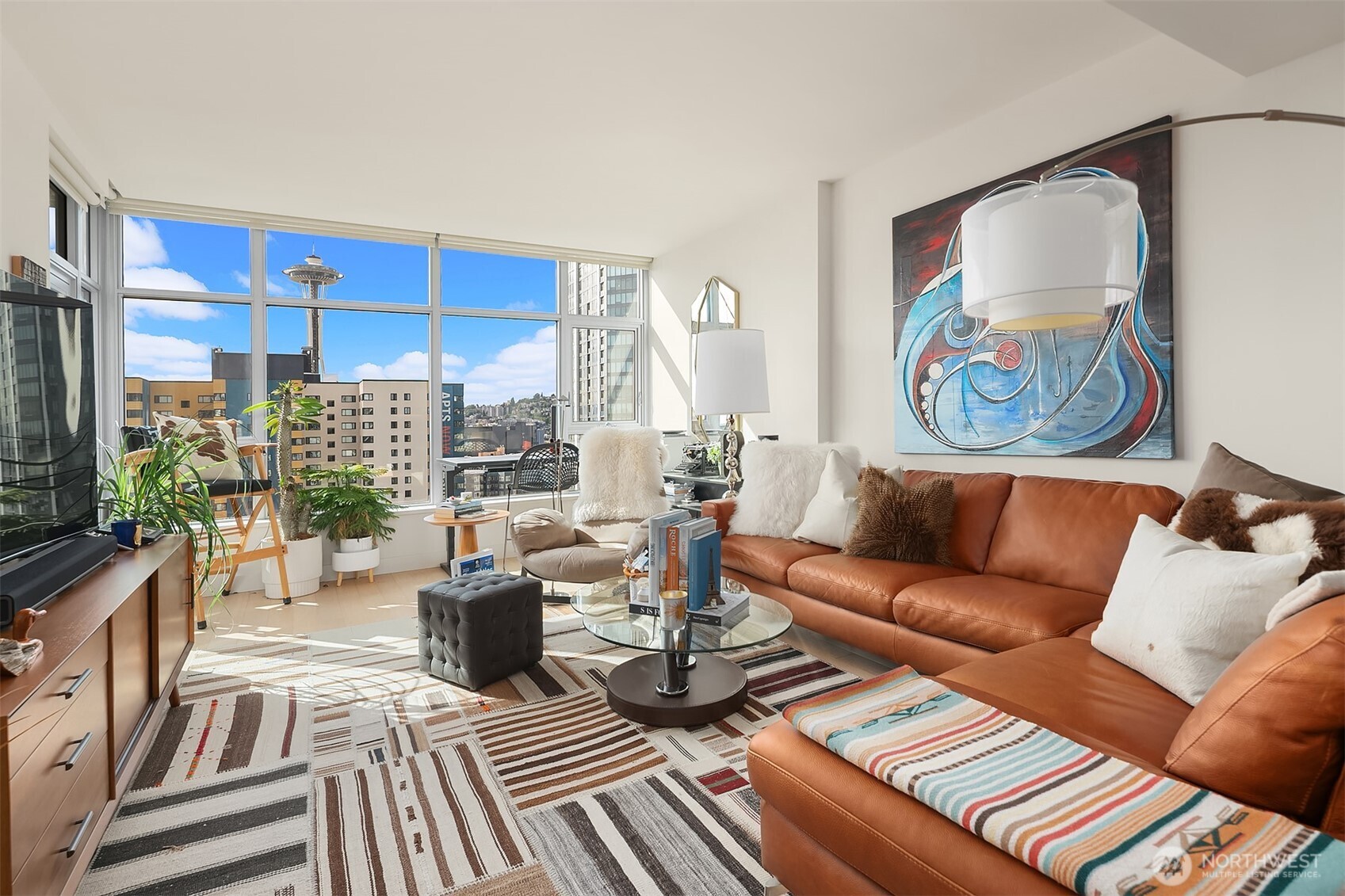 583 Battery Street, Unit 1405N Seattle, WA 98121 - Photo 4 of 37 a living room with furniture a rug and a floor to ceiling window