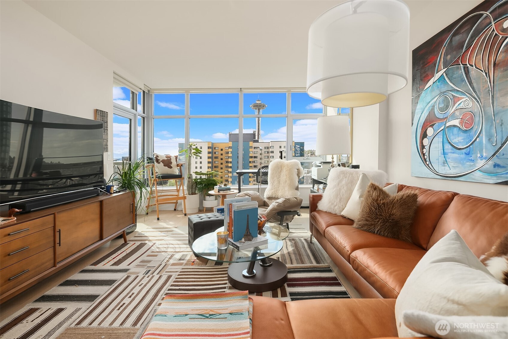 583 Battery Street, Unit 1405N Seattle, WA 98121 - Photo 5 of 37 a living room with furniture and a flat screen tv