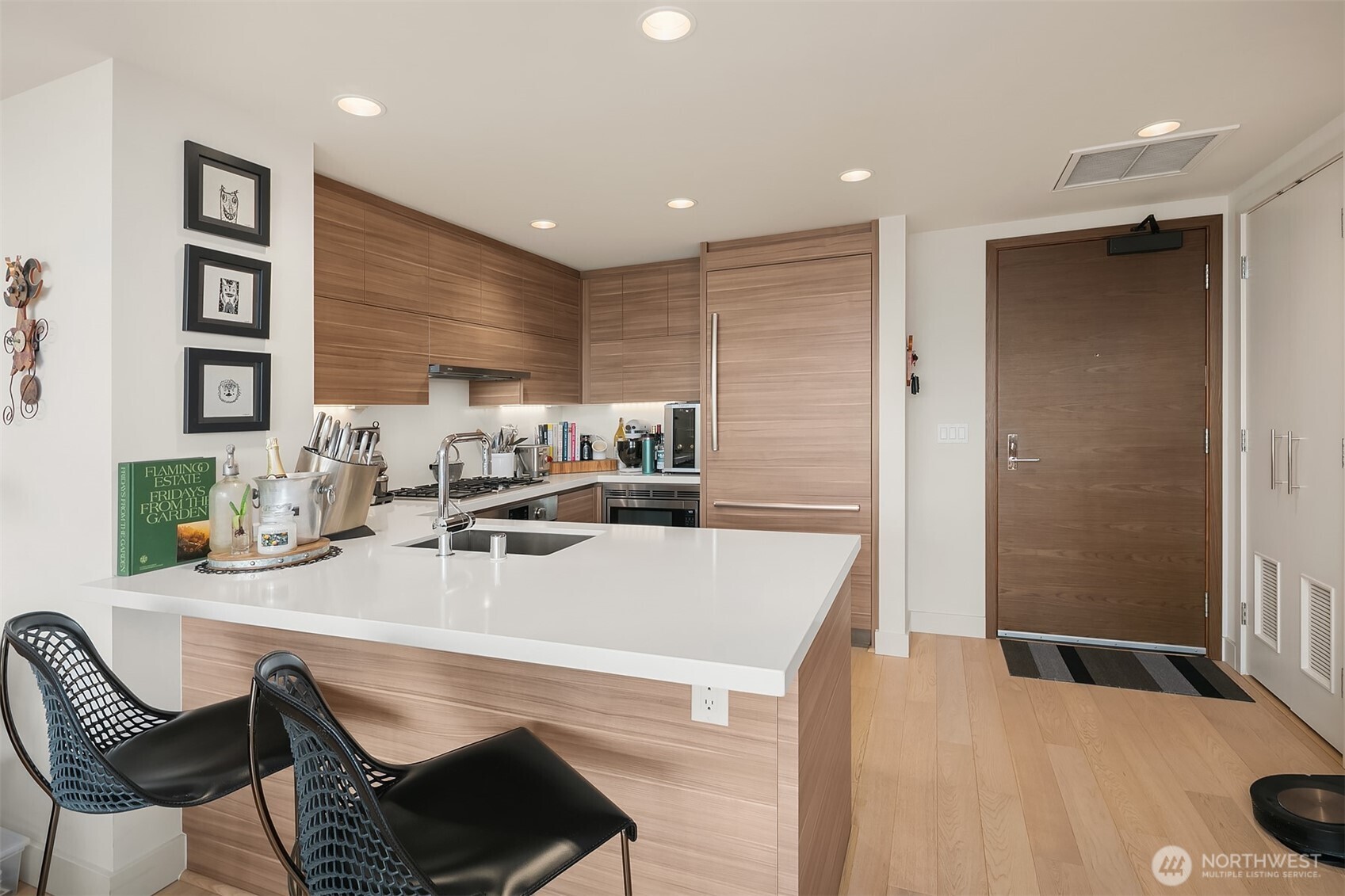 583 Battery Street, Unit 1405N Seattle, WA 98121 - Photo 7 of 37 a kitchen with a table chairs stove and kitchen island