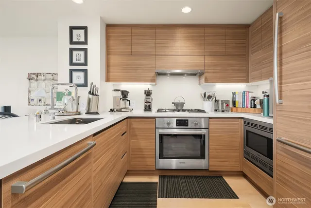 a kitchen with stainless steel appliances a stove and cabinets
