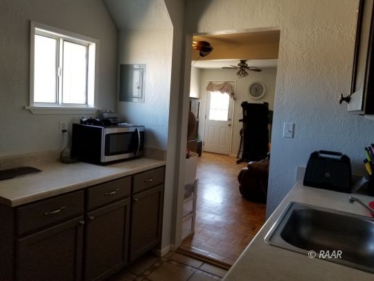 1165 Cory Street Ridgecrest, CA 93555 - Photo 21 of 26 a kitchen with a refrigerator and a sink