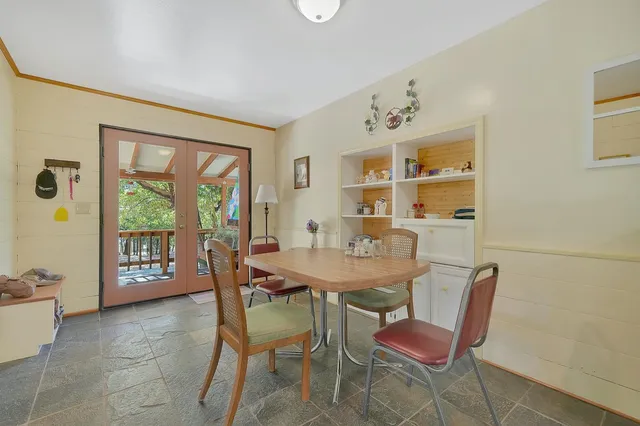 a living room with furniture large window and flat screen tv