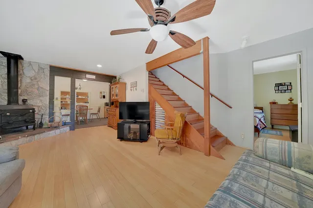 a bed room with a bed a book shelf and a window