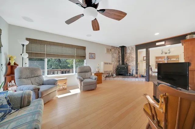 a bedroom with a bed table and a window