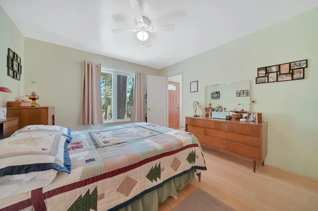 a bedroom with a bed and a desk