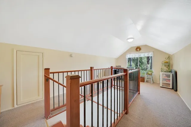 a view of staircase with railing and stairs