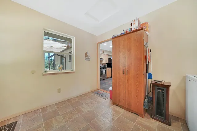 a kitchen with granite countertop a stove a sink and a microwave