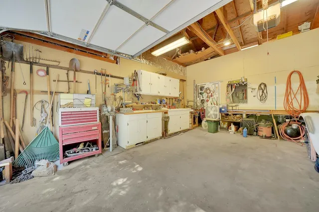 a view of a house with backyard and trees