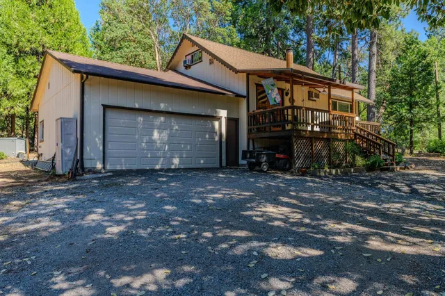 an aerial view of a house with a yard and balcony