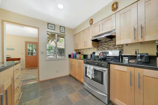 a kitchen with stainless steel appliances granite countertop a sink and cabinets