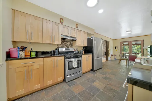 a view of a dining room with furniture and a potted plant