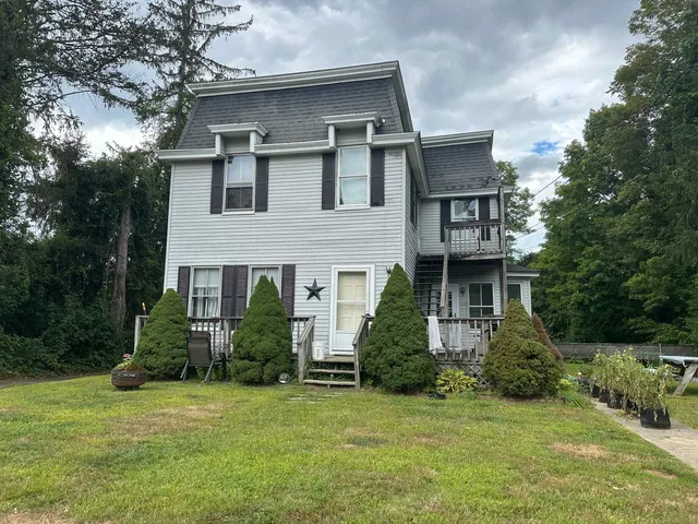 a front view of a house with a garden