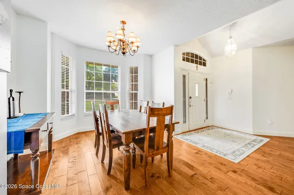 a view of a hallway with furniture and wooden floor