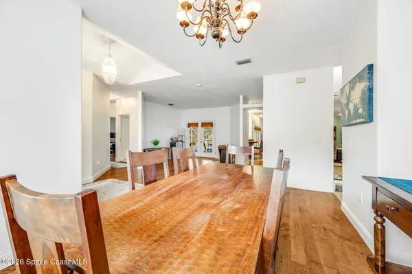 a kitchen with stainless steel appliances white cabinets and a refrigerator