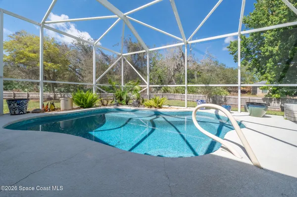 a kitchen with granite countertop a sink stainless steel appliances and cabinets