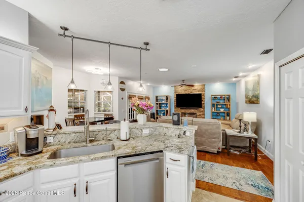 a living room with dining room and wooden floor