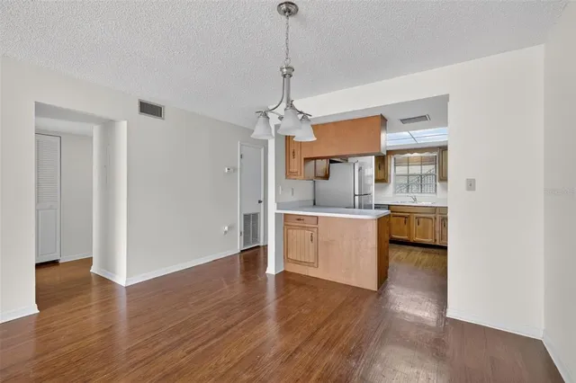 a large kitchen with sink and cabinets