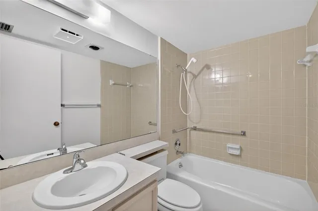 a bathroom with a sink toilet tub and shower
