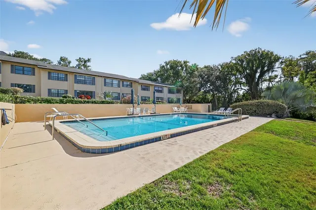 a view of a house with swimming pool and sitting area