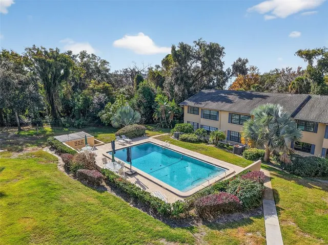 a view of a house with swimming pool and yard