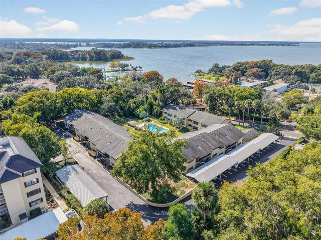 an aerial view of a house with a garden and lake view