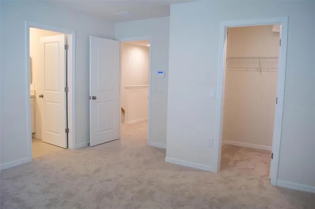 an empty room with windows and closet