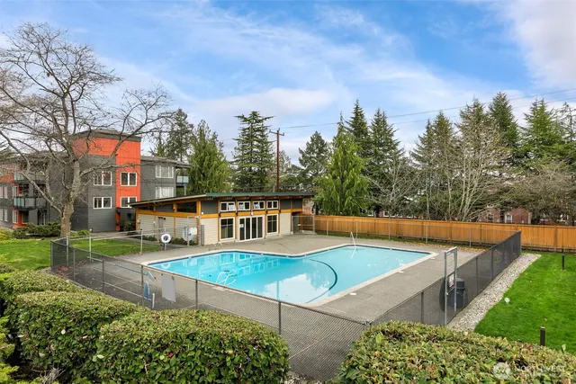 a dining room with furniture and a floor to ceiling window