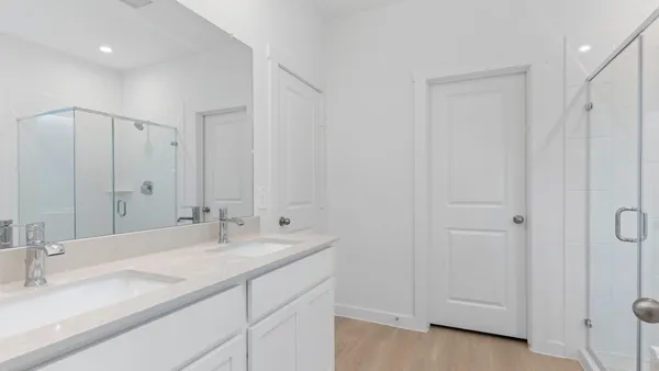 a bathroom with double vanity sink and a mirror