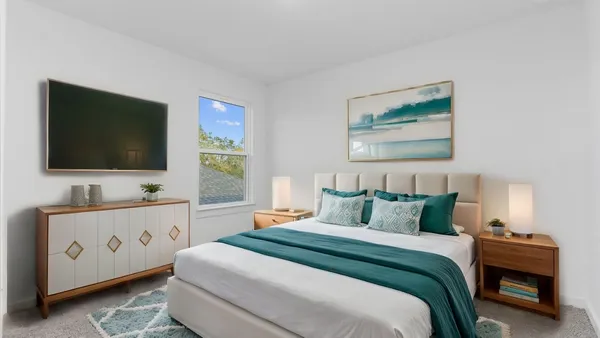 a bedroom with a bed and a flat screen tv