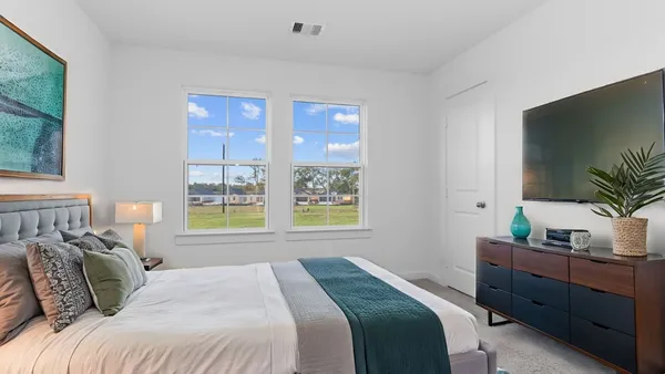 a bedroom with a large bed and a window