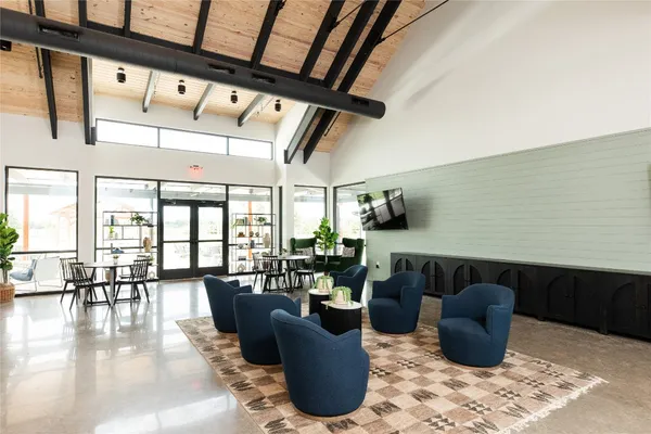 a living room with furniture and a floor to ceiling window