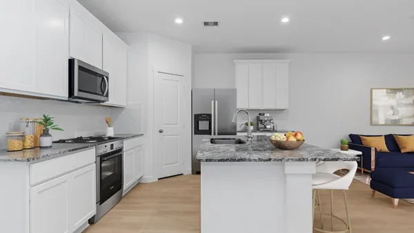 a kitchen with stainless steel appliances granite countertop a sink stove and microwave