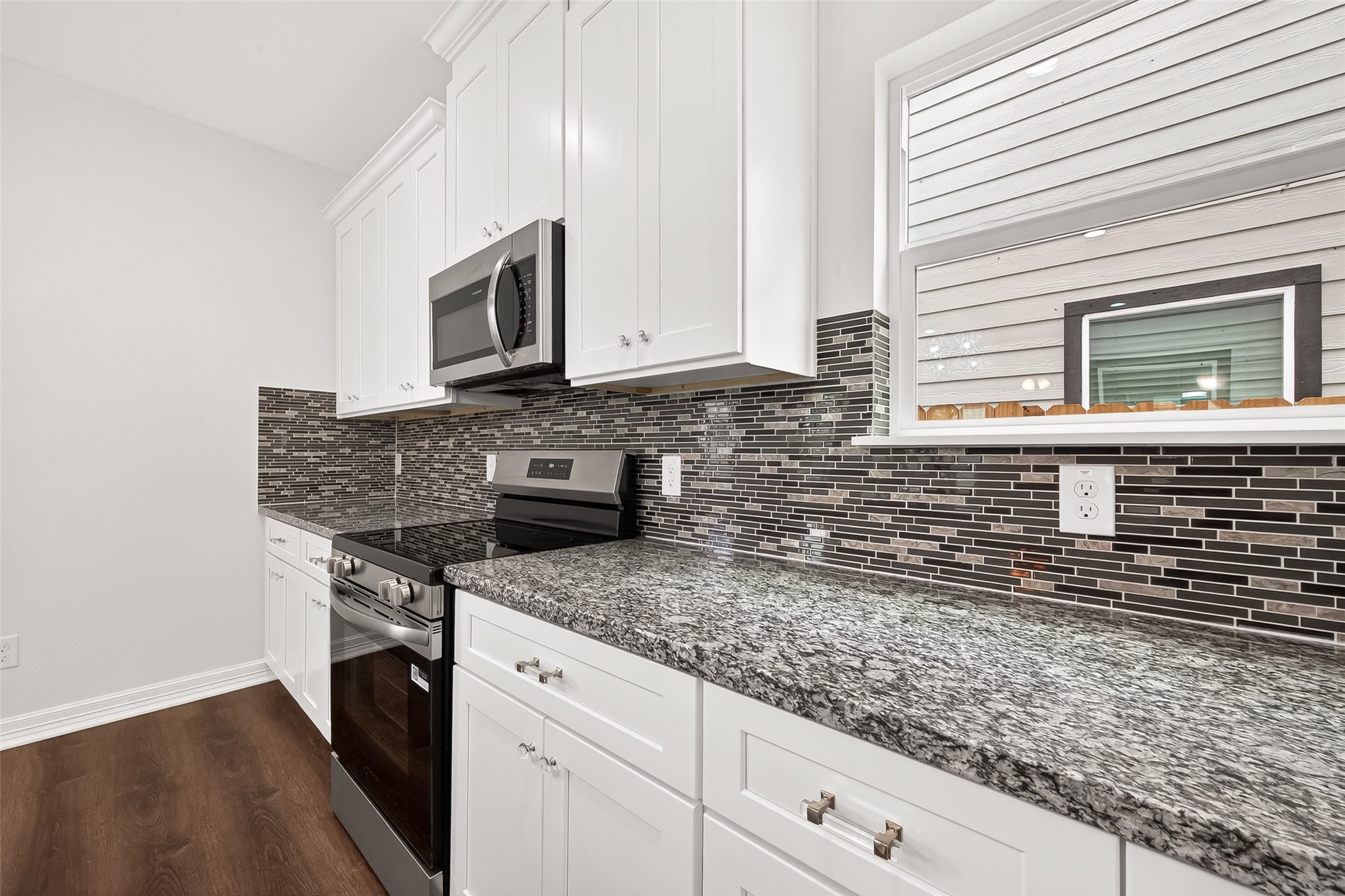 422 North 4th Street Beasley, TX 77417 - Photo 11 of 25 a kitchen with stainless steel appliances granite countertop a sink stove and microwave