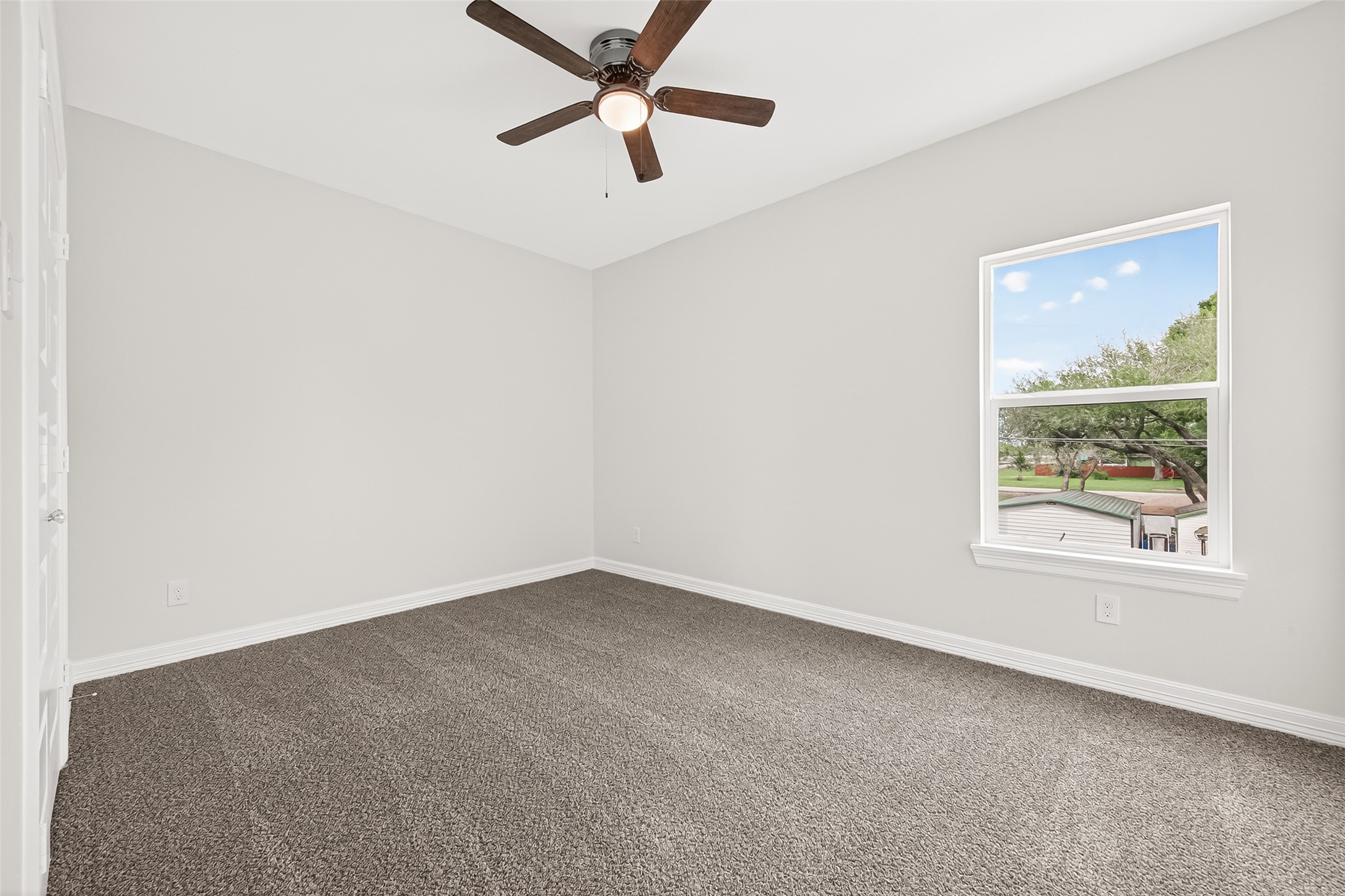 422 North 4th Street Beasley, TX 77417 - Photo 16 of 25 an empty room with a window and a fan