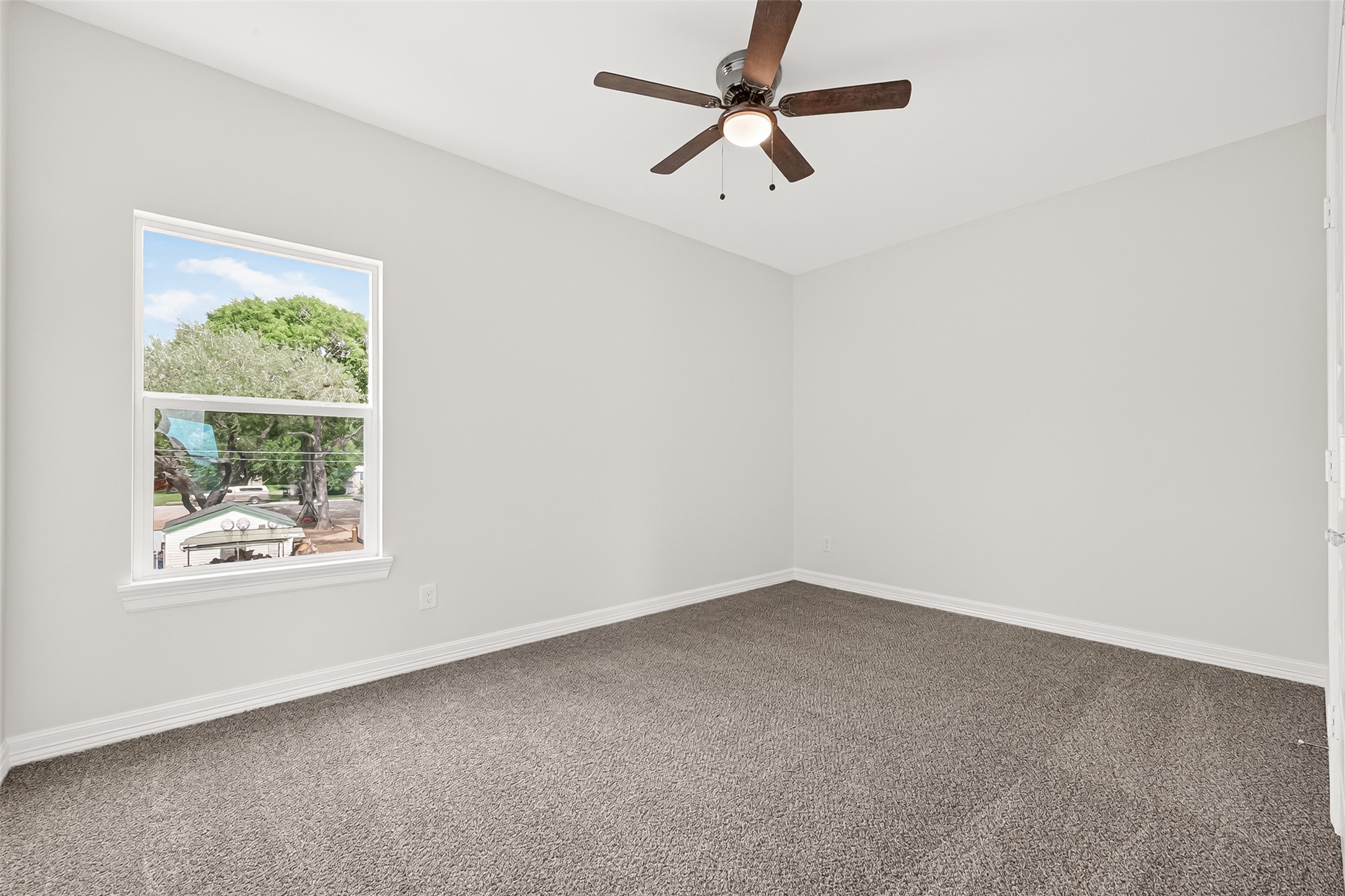 422 North 4th Street Beasley, TX 77417 - Photo 20 of 25 an empty room with a window and a fan