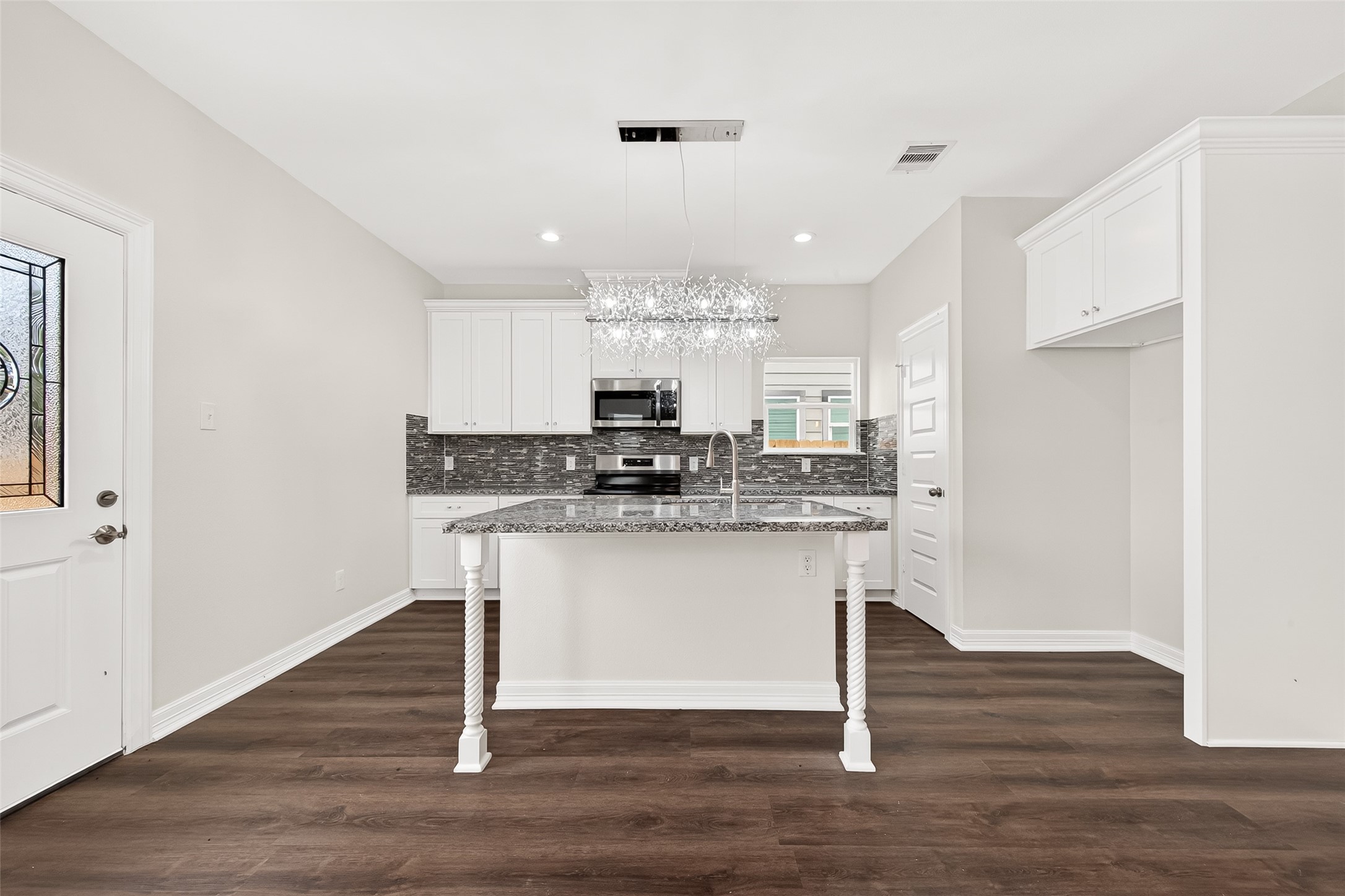 422 North 4th Street Beasley, TX 77417 - Photo 9 of 25 a kitchen with kitchen island granite countertop a sink cabinets and wooden floor