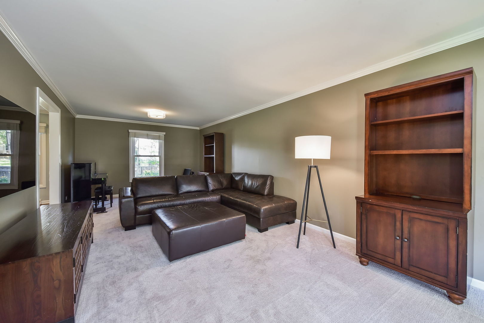 1325 Culpepper Drive Naperville, IL 60540 - Photo 17 of 34 a living room with furniture and a flat screen tv