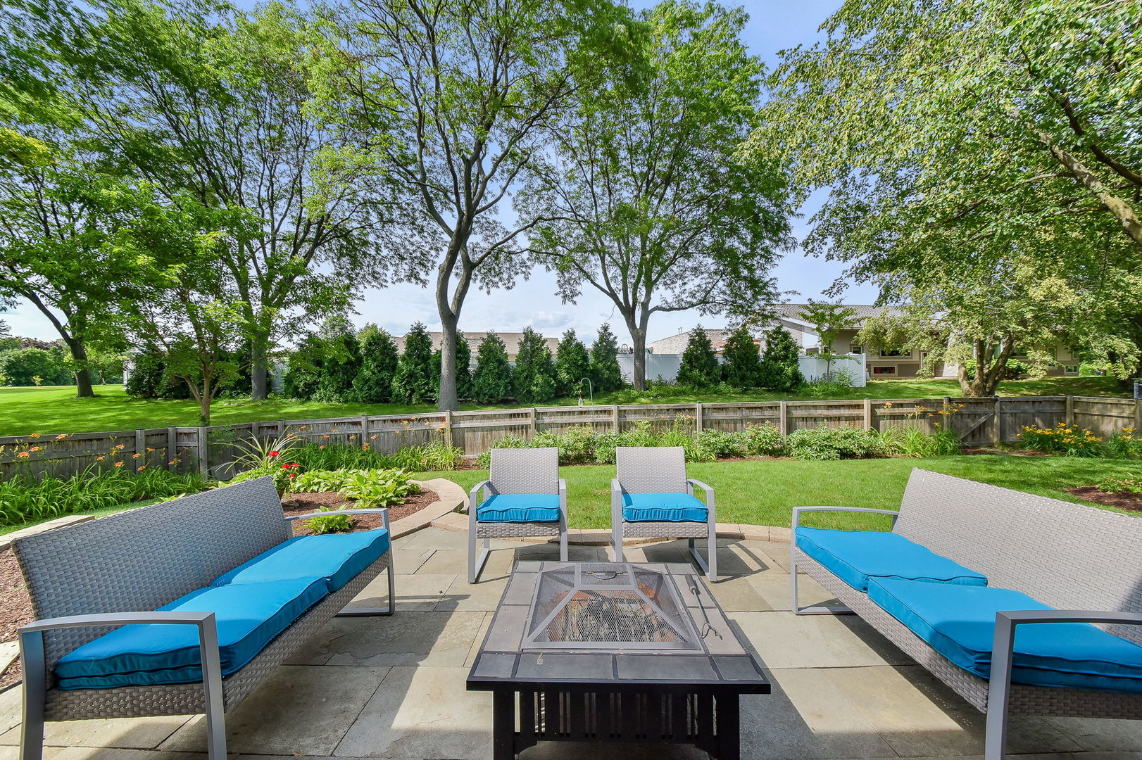 1325 Culpepper Drive Naperville, IL 60540 - Photo 28 of 34 a view of a deck with couches table and chairs next to an umbrella
