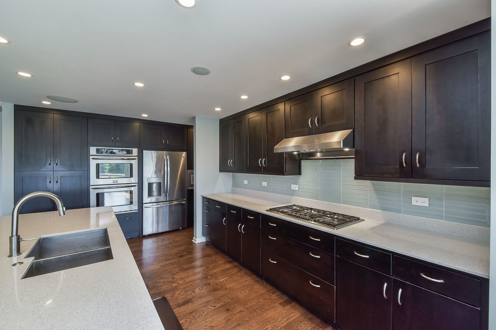 1325 Culpepper Drive Naperville, IL 60540 - Photo 7 of 34 a large kitchen with stainless steel appliances a sink a stove and a wooden cabinets