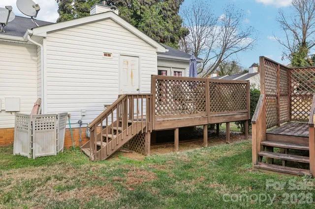 a view of a house with a yard and deck