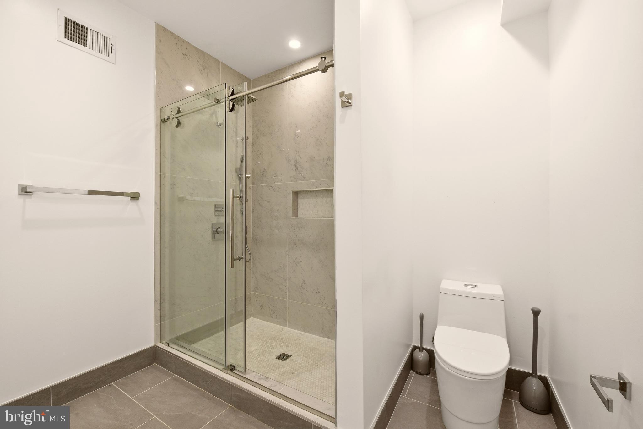 1023 16th Street Northeast, Unit B Washington, DC 20002 - Photo 20 of 25 a bathroom with a shower and toilet