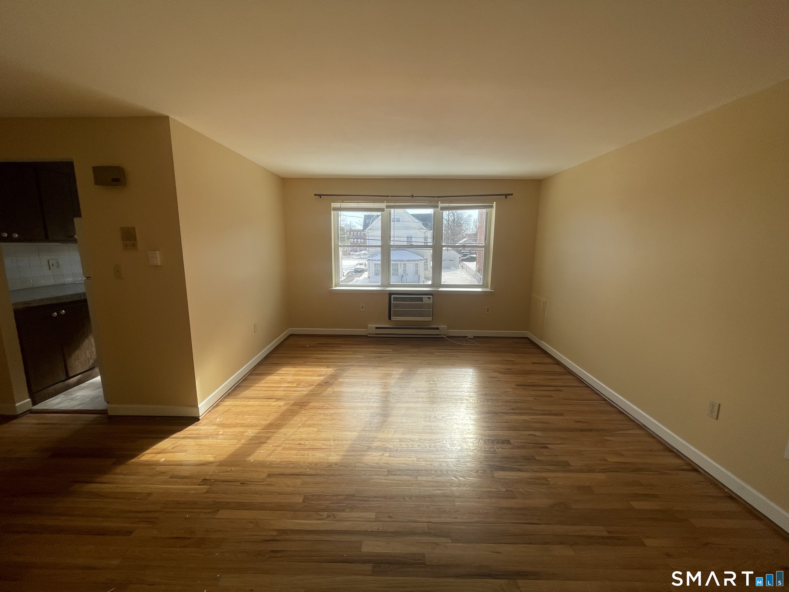 24 Merrill Street, Unit B3 Hartford, CT 06106 - Photo 3 of 9 a view of empty room with wooden floor and fan