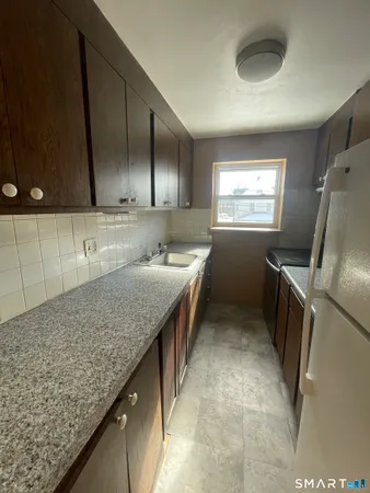 a kitchen with a sink a counter top space and appliances