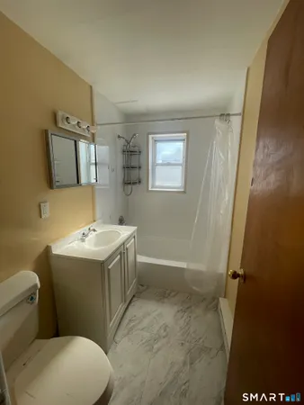 a view of bathroom with a sink and mirror