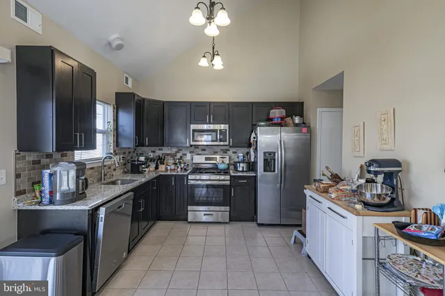 a kitchen with a refrigerator stove and sink