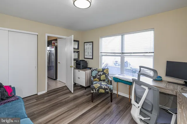 a view of a workspace with furniture and a window