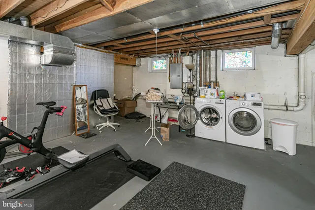 a utility room with dryer washer and other items
