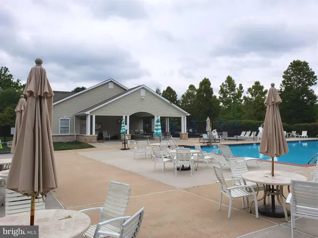 a view of a house with backyard and a sitting area